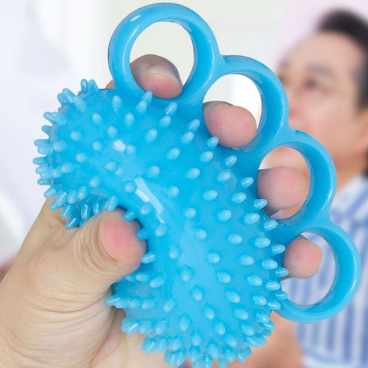 Person squeezing blue textured hand grip and finger exerciser ball with four-finger loop design NZ