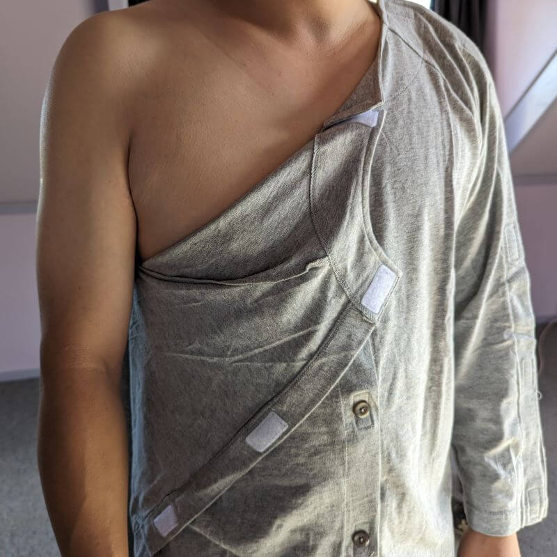 Adaptive long sleeve top shown fully open along the side seam, Velcro fastenings visible allowing complete arm access for dressing around casts dressings or limited shoulder mobility NZ