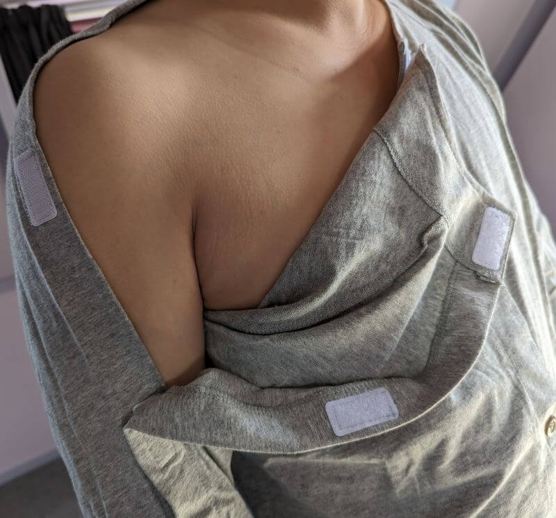 Adaptive long sleeve top shown with side Velcro fastenings open at the shoulder, full arm opening allows dressing without lifting or bending the arm NZ