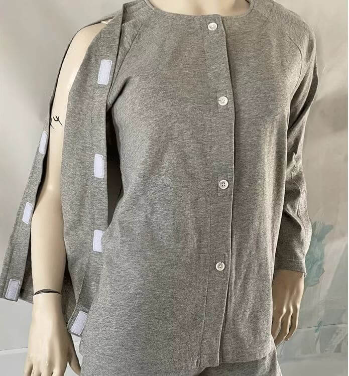 Adaptive long sleeve top worn on mannequin showing front closure and side Velcro arm opening, dual fastening system for easy independent or carer-assisted dressing NZ