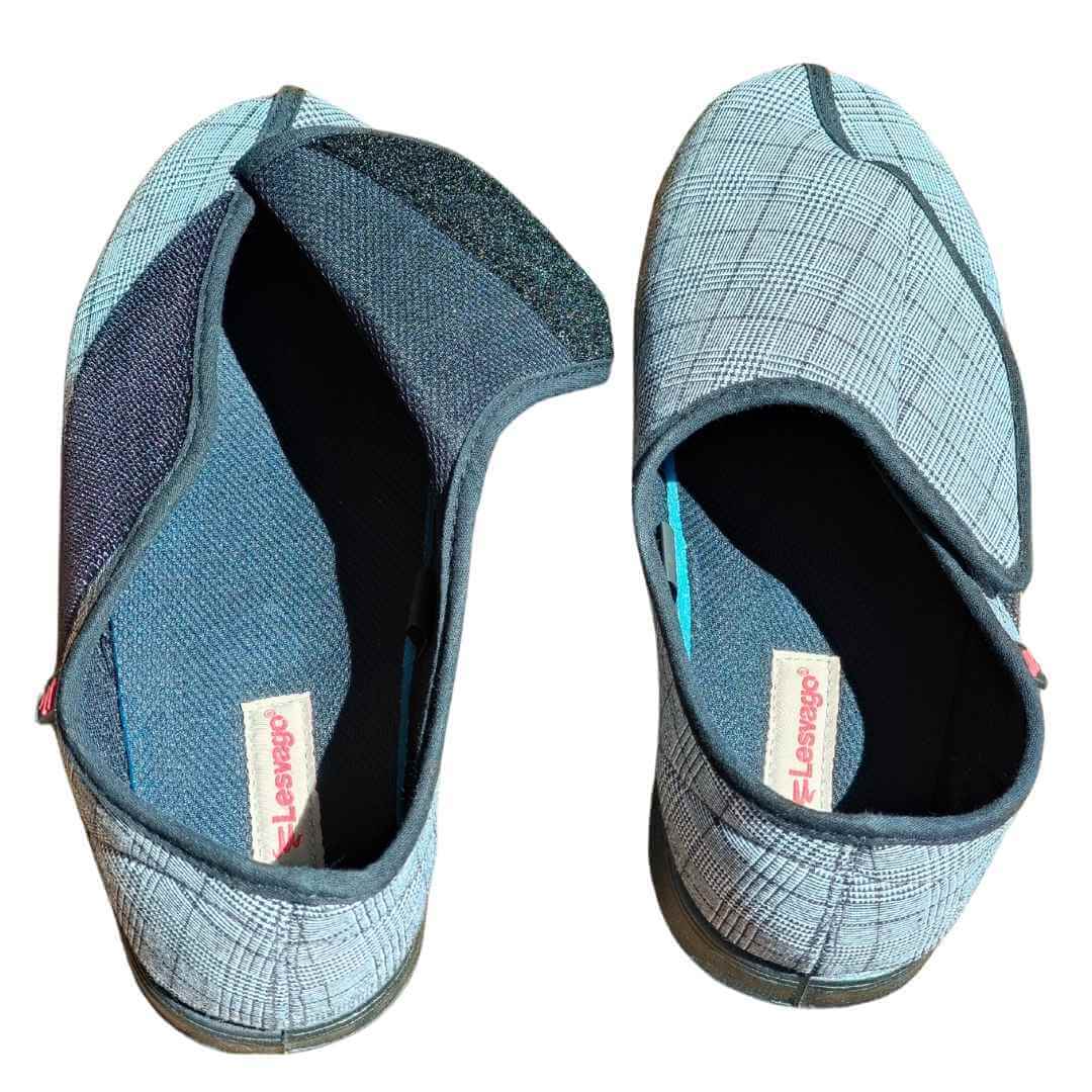 Pair of adaptive slippers shown from above with Velcro fastening flap open, wide entry design showing cushioned interior for easy dressing with swollen feet or limited mobility NZ