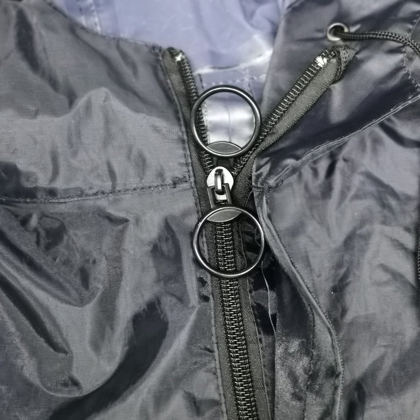 Close-up of the Mobility Scooter Rain Poncho's front zip neck closure