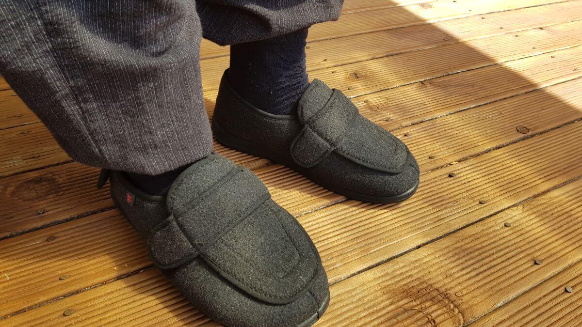 Person wearing Owen's Oasis adjustable slippers with wide velcro straps, NZ