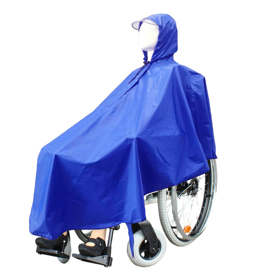 Person seated in a wheelchair wearing the navy blue Wheelchair Rain Poncho with hood up