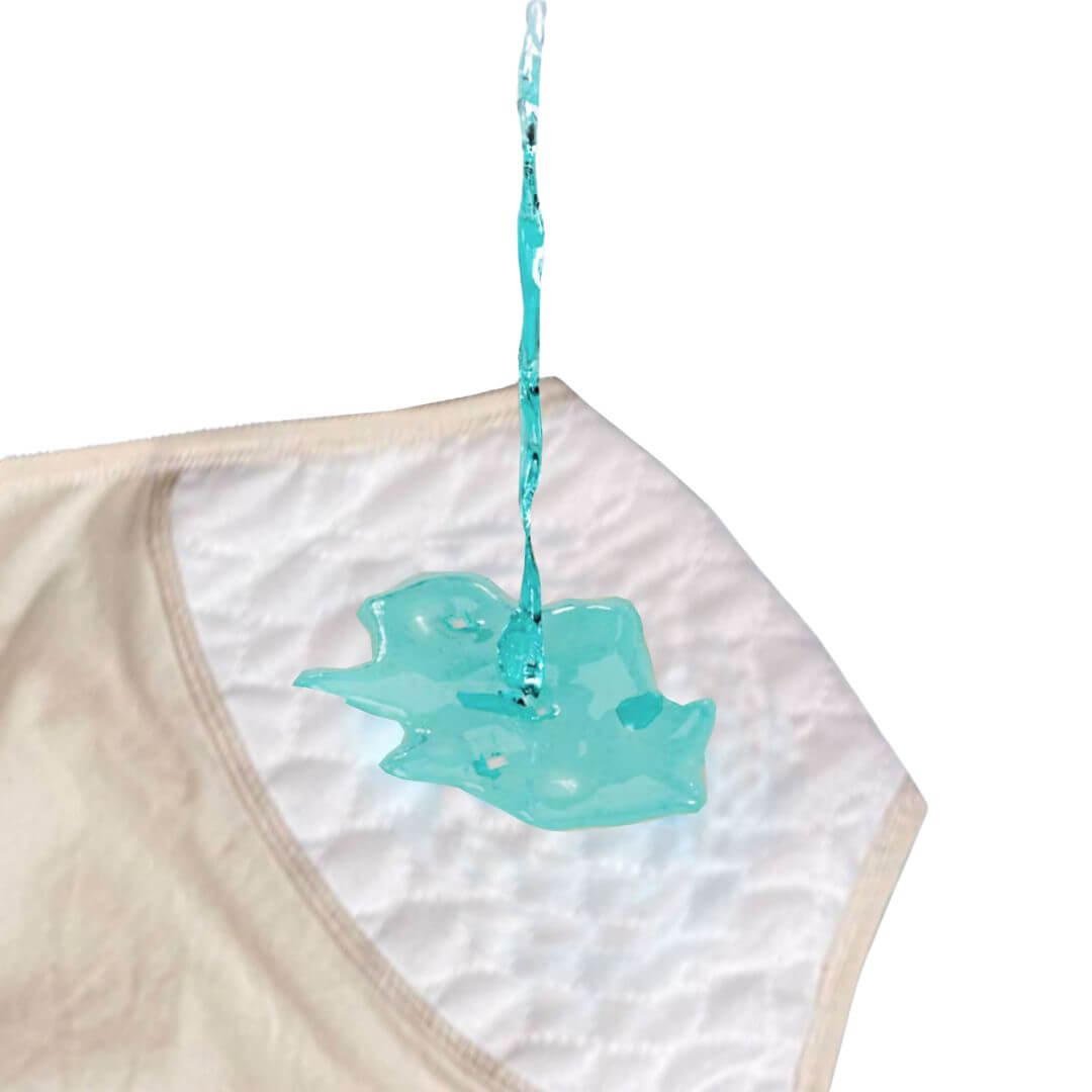 Water poured onto women's washable incontinence underwear 
absorbent panel, demonstrating fast absorption into the 4-layer leak-proof construction NZ