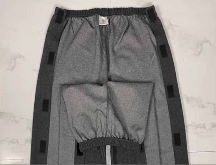 Adaptive pants with full-length Velcro side openings and front drop down access