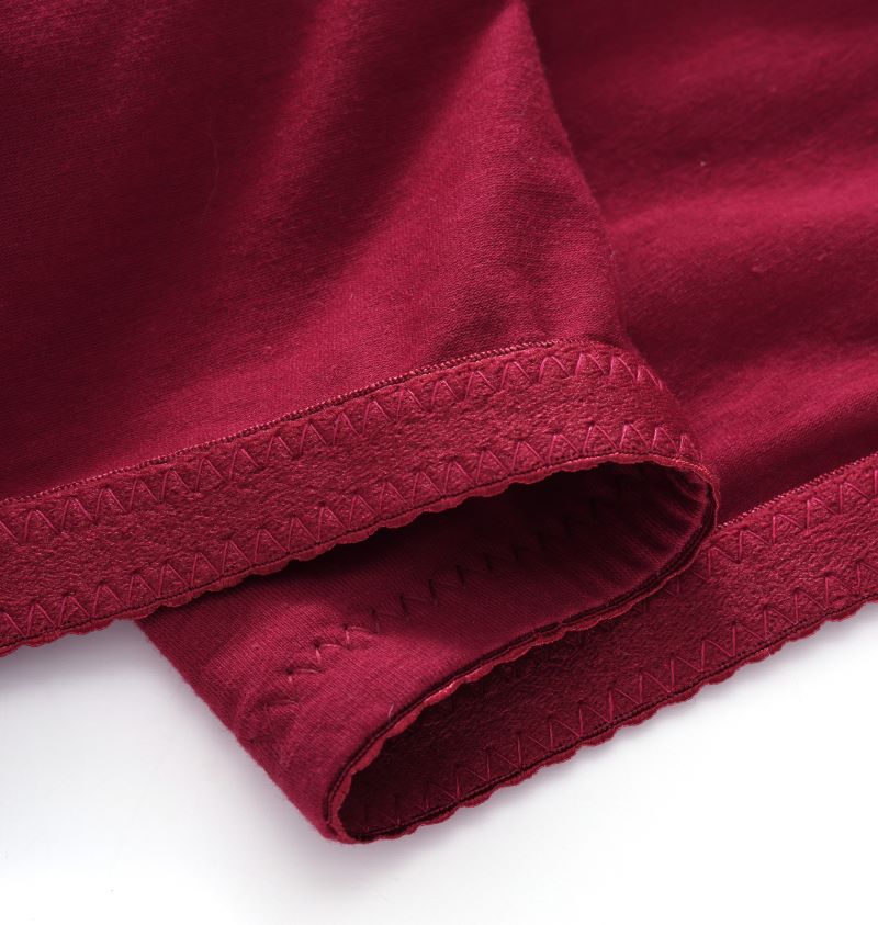 Close-up of wine red fuller bust adaptive bra fabric and soft finished edge.