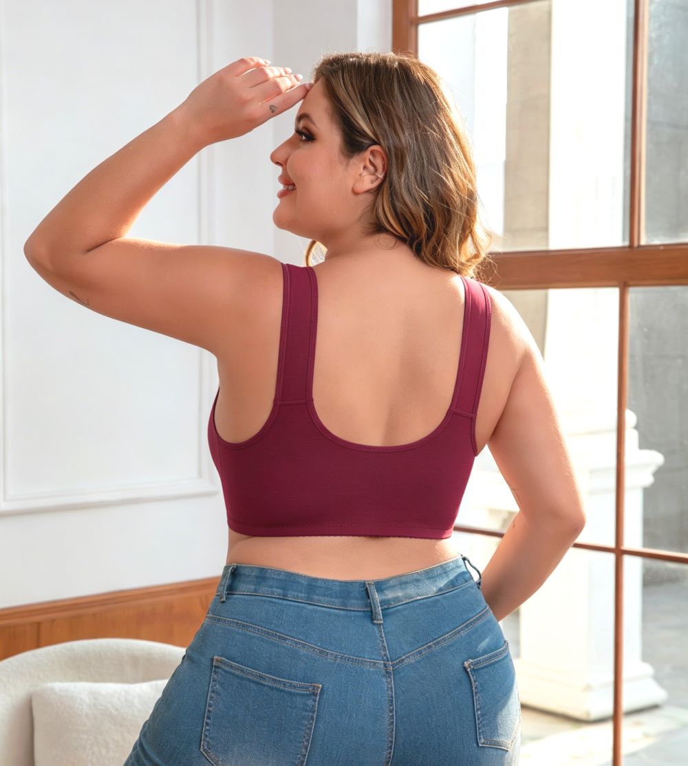Woman wearing wine red fuller bust front opening adaptive bra, shown from the back with wide fixed shoulder straps.