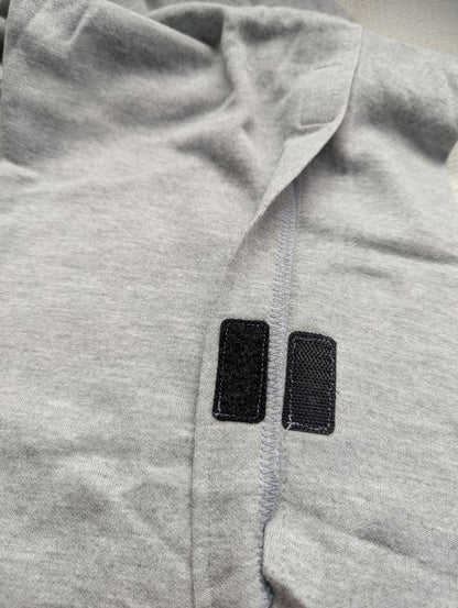 Close-up of Velcro side closure on light grey adaptive tear-away pants