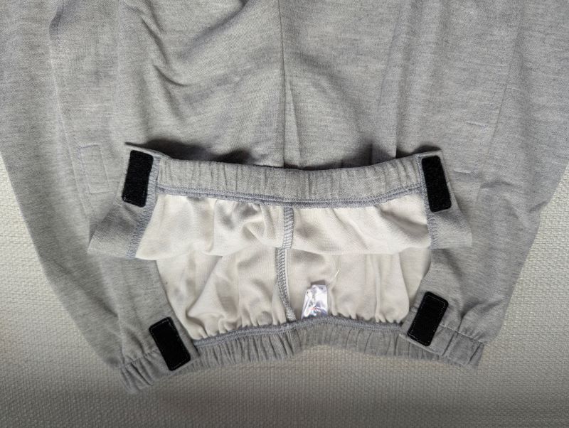 Light grey unisex tear-away pants opened at the waist showing full side Velcro fastening
