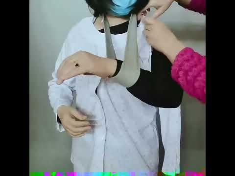 Demonstration of a women’s adaptive full-opening top being wrapped and fastened around an arm in a sling for easier dressing.